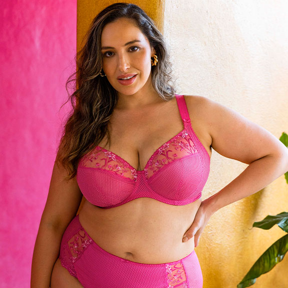Modal wearing a pink plunge bra and matching high leg brief